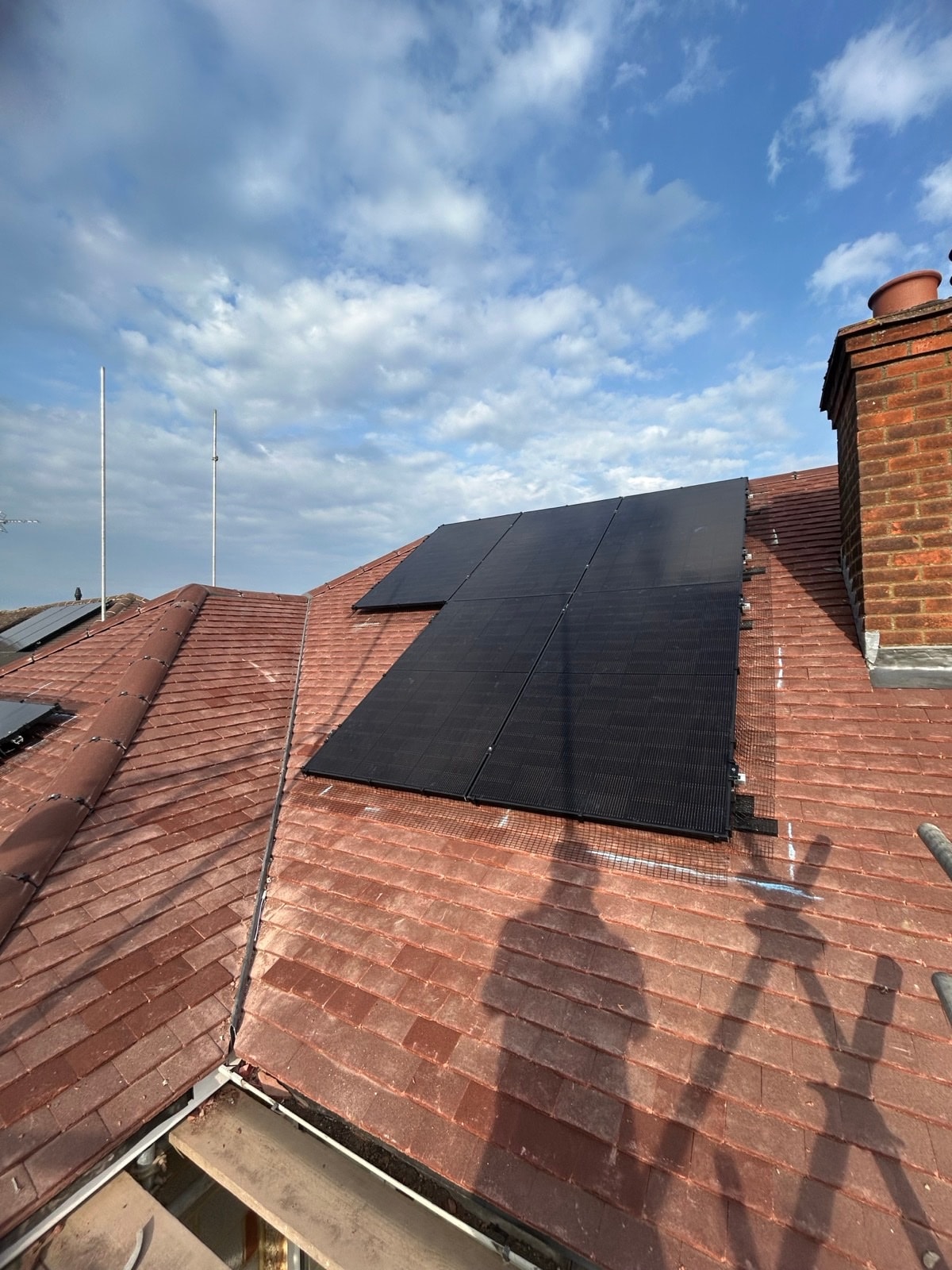 Black solar panels installed on a residential tiled roof in Hertfordshire
